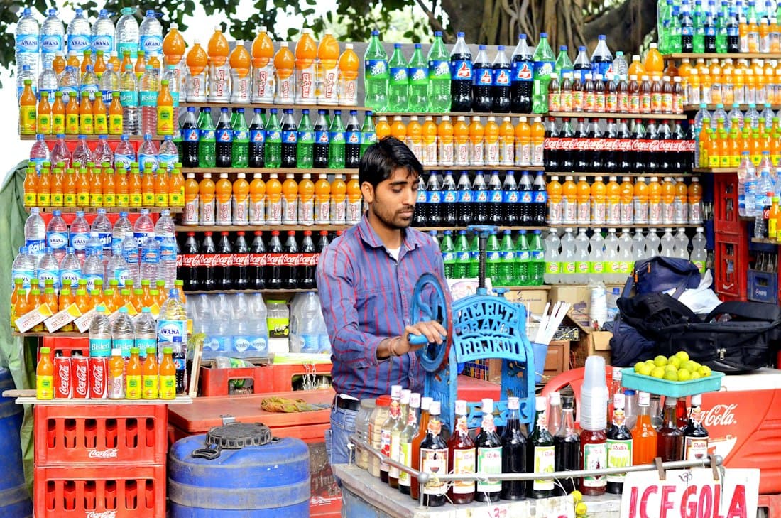 Shop owner arranging cold drinks and packaged goods